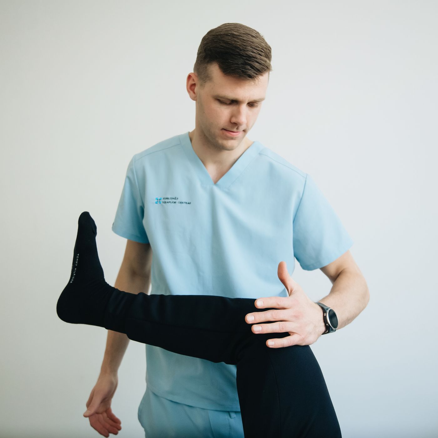 Owen Castellano assessing a patient's hip flexion in the clinic
