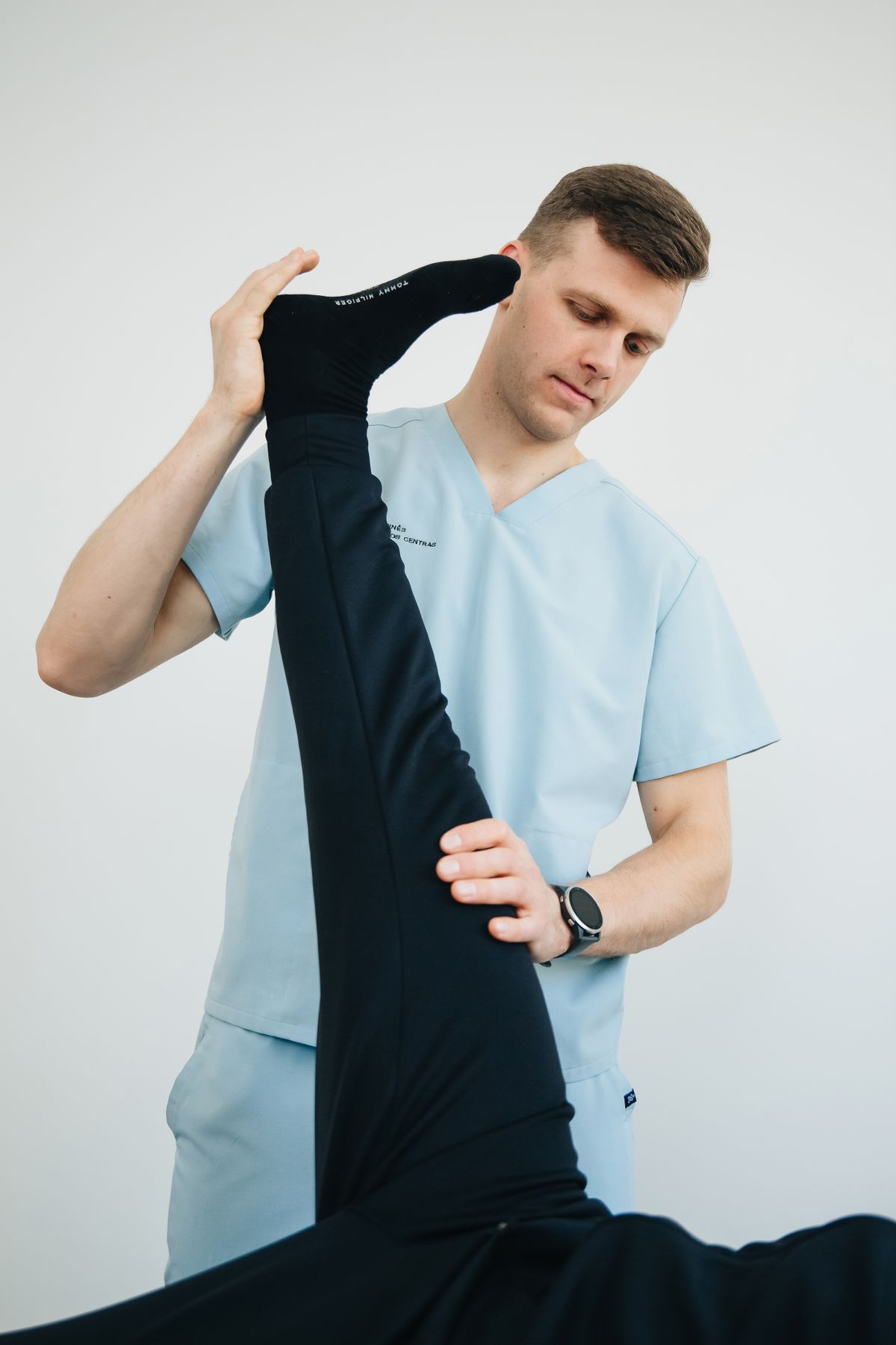 Owen measuring how far a patient's straight leg lifts